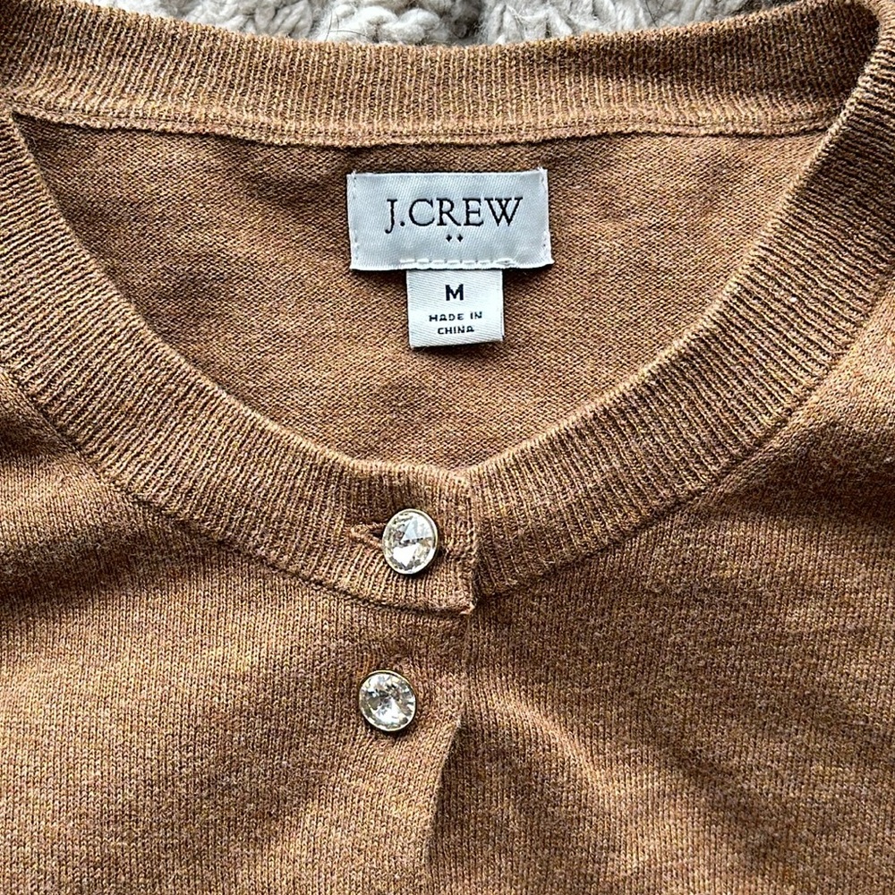 Fancy jeweled button, caramel colored cardigan.